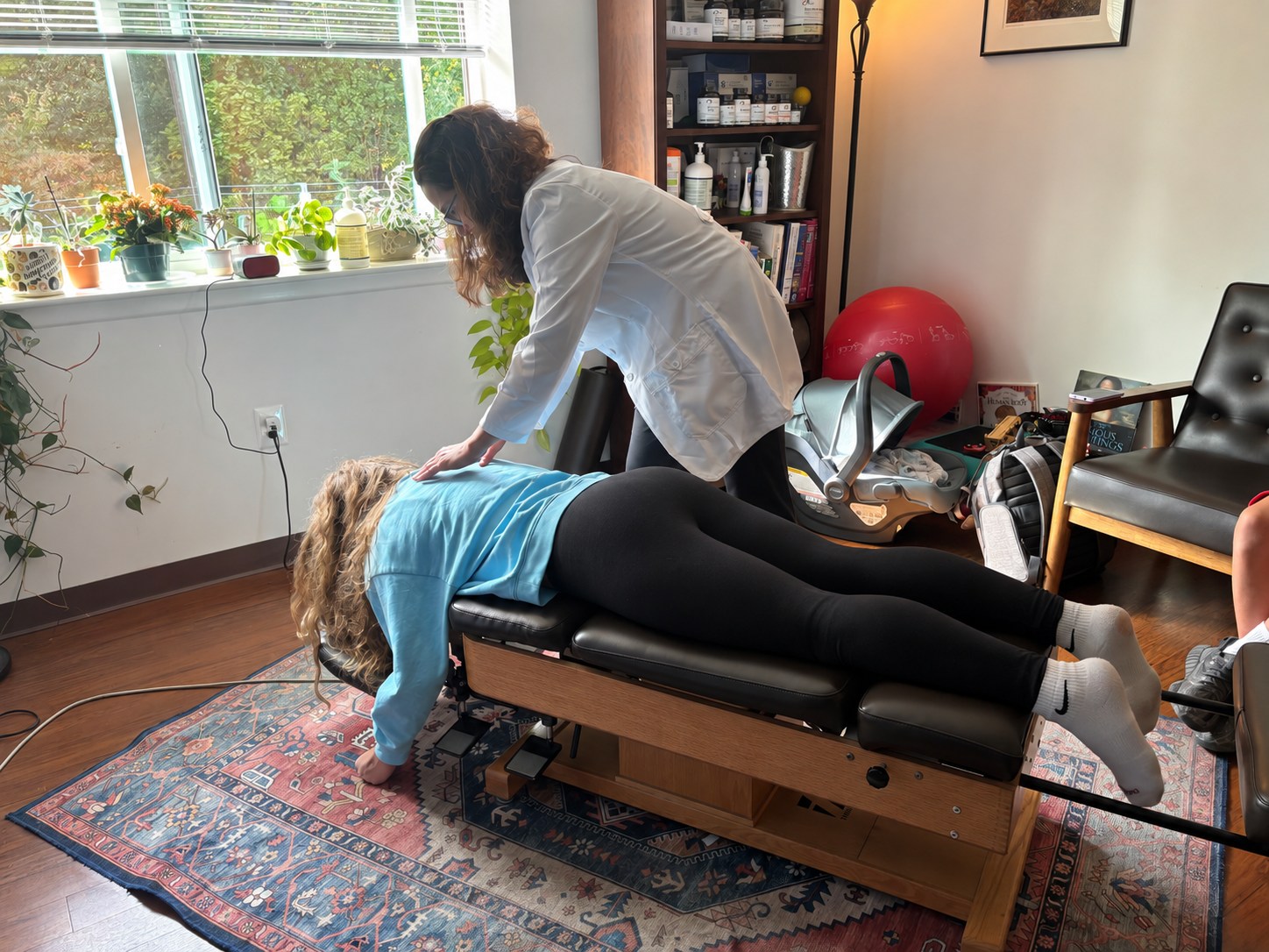 Dr. Cara Hillwig providing hands-on chiropractic care in her Haverford office