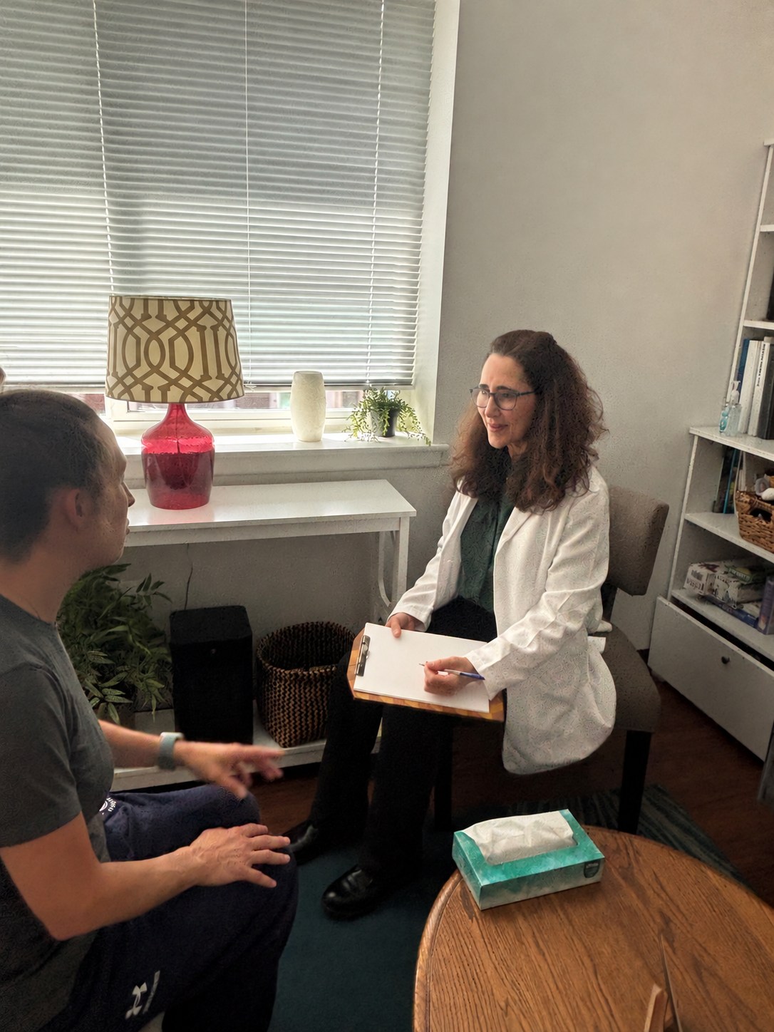 Dr. Cara Hillwig discussing nutrition with a patient in her Haverford office